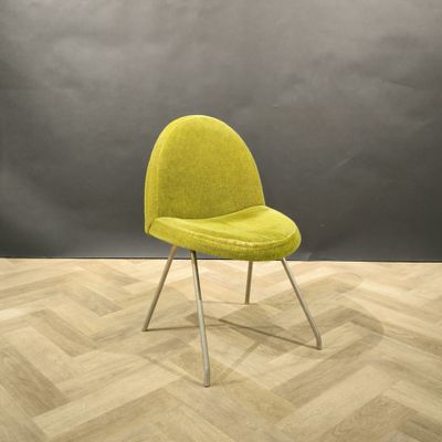 an image of a yellow chair sitting on top of a wooden floor