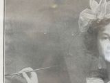 a black and white photo of a woman holding a paintbrush