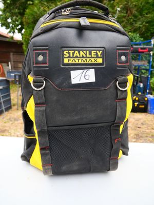 a black and yellow backpack with a name tag on it