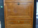 a wooden chest of drawers with a marble top