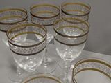 a lot of glasses sitting on a white table