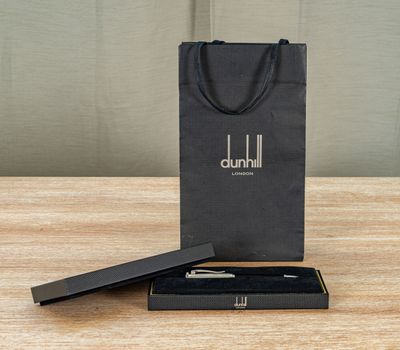 a close up of a black gift bag with a pen in it