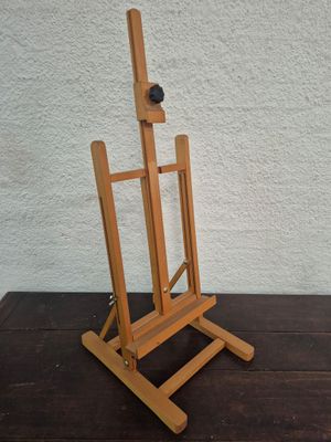 a wooden easel with a ball on top of it