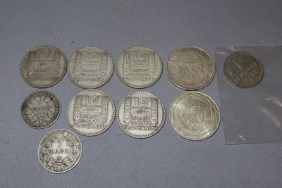 some silver coins sitting on top of a table next to a plastic bag