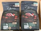 two bags of cherie dog food sitting on top of a cardboard box