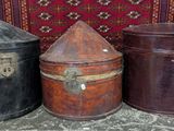 three old suitcases sitting next to each other on a rug