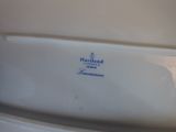 a white toilet with a blue lid in a bathroom