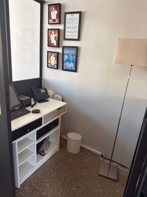 a desk with a laptop on it in the corner of a room