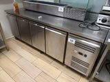 stainless steel counter top in a commercial kitchen with stainless steel appliances