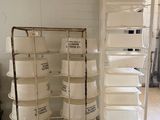 many white containers stacked on a cart in a room
