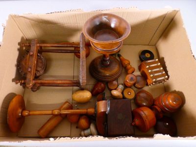 a cardboard box filled with different types of wooden objects