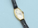 a close up of a wrist watch on a blue surface