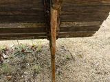 a wooden bench that is sitting in the dirt