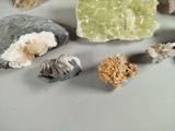 many different colored rocks on a white surface