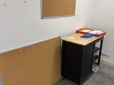 an image of a room with a desk and a bulletin board