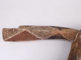 a wooden object that is on a white surface