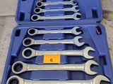 a set of wrenches in a blue case sitting on the ground