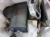 a suitcase that is sitting on top of a pile of stuff