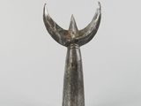 an image of a silver sculpture of a bird ' s head