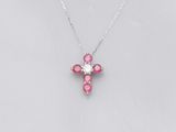 a small pink cross necklace on a silver chain