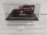 an old model of a red truck in a clear case