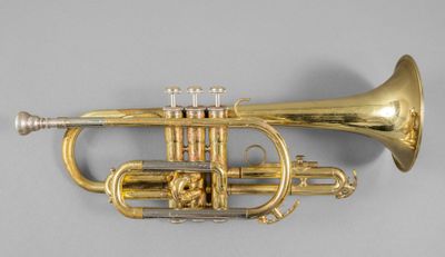 an image of a brass trumpet on a gray background