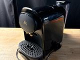 an image of a black coffee maker on a wooden table