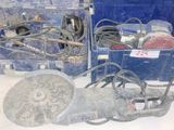 two blue boxes with tools in them on a table
