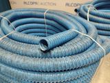 blue hoses are stacked on top of each other on a table
