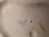 a close up view of a porcelain figurine of a cat