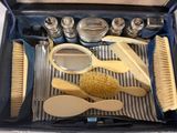 a suitcase that has a lot of brushes and other items in it