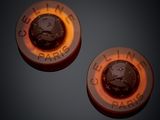 pair of two orange and black buttons with a picture of a man ' s face on them