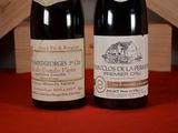 two bottles of wine sitting next to each other on a table
