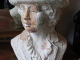 a statue of a woman with a hat on top of her head