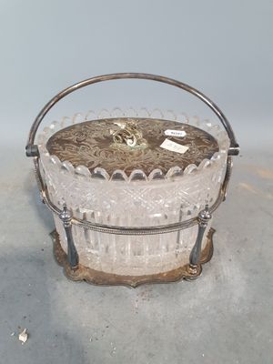 a small glass basket with a handle on a table