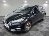 the black nissan versa is parked on a checkered floor
