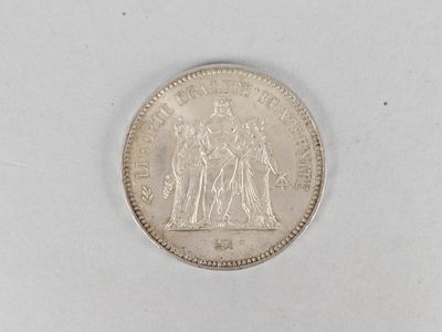 an old silver coin on a white surface with a white background