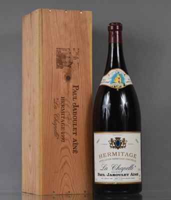 a bottle of wine sitting next to a wooden box