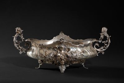 an antique silver plated bowl on a black background with a black background
