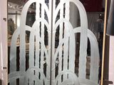 a frosted glass door with a decorative design on it