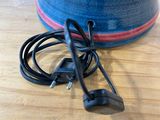 a cord that is connected to a speaker on a table
