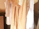 a lot of clothes hanging on a rack in a room