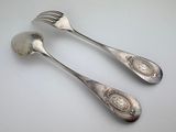 pair of silver plated spoons and fork on a white surface