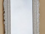 an image of a mirror hanging on a wall in a room