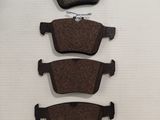 a set of four brake pads on a white background