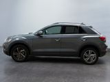 the volkswagen suv is parked in a large room with a gray background