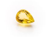 a yellow sapphire stone on a white background