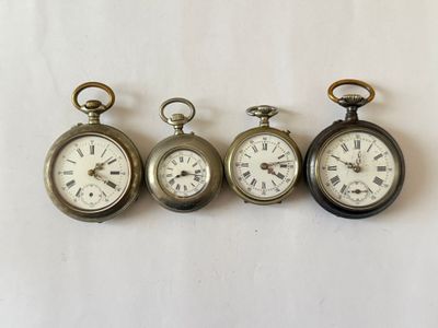 four antique pocket watches are lined up in a row on a white surface