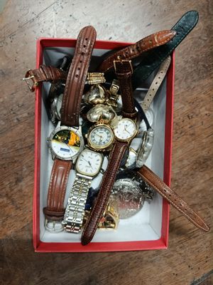 a box full of watches and other watches on a table