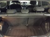 the back of a car with its trunk open and the seats folded down